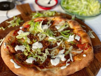 pizza met pittig gehakt, ijsbergsla en frisse saus