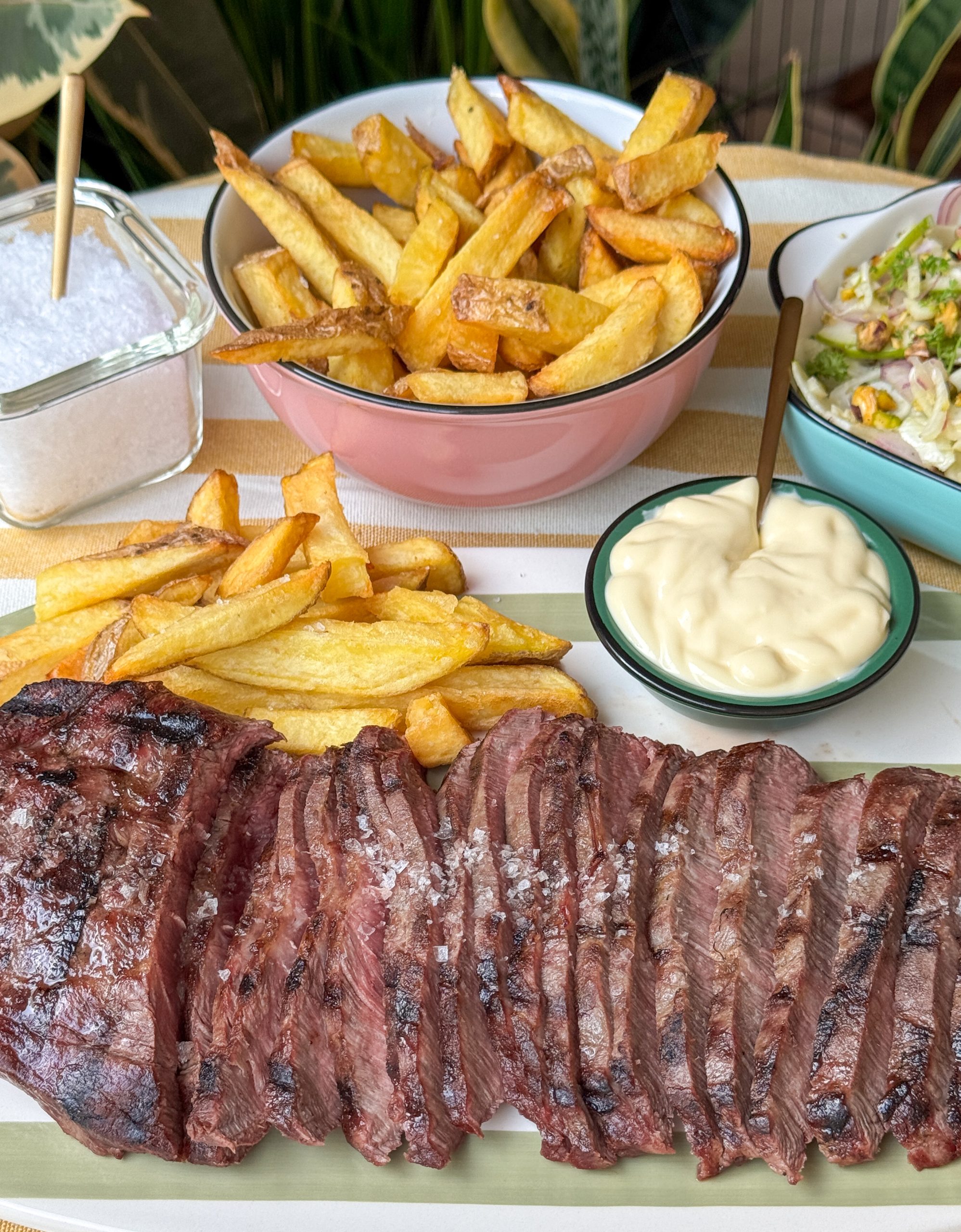 flat iron steak van de bbq geserveerd met friet en venkelsalade