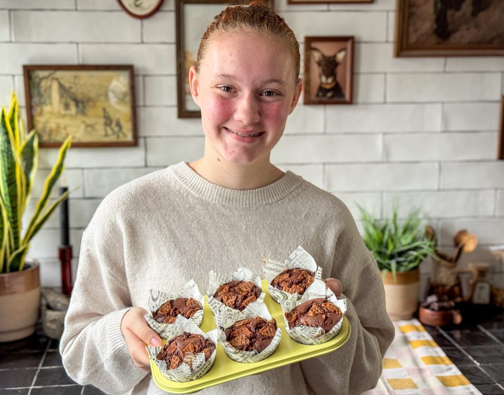 Amaranthe houdt schaal met zelfgebakken chocolade muffins met stroopwafel vast