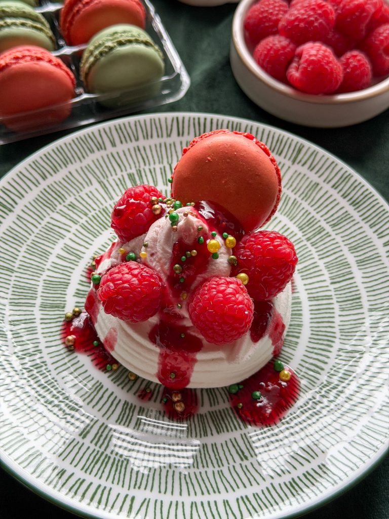 Pavlova met frambozensaus, frambozen en macaron