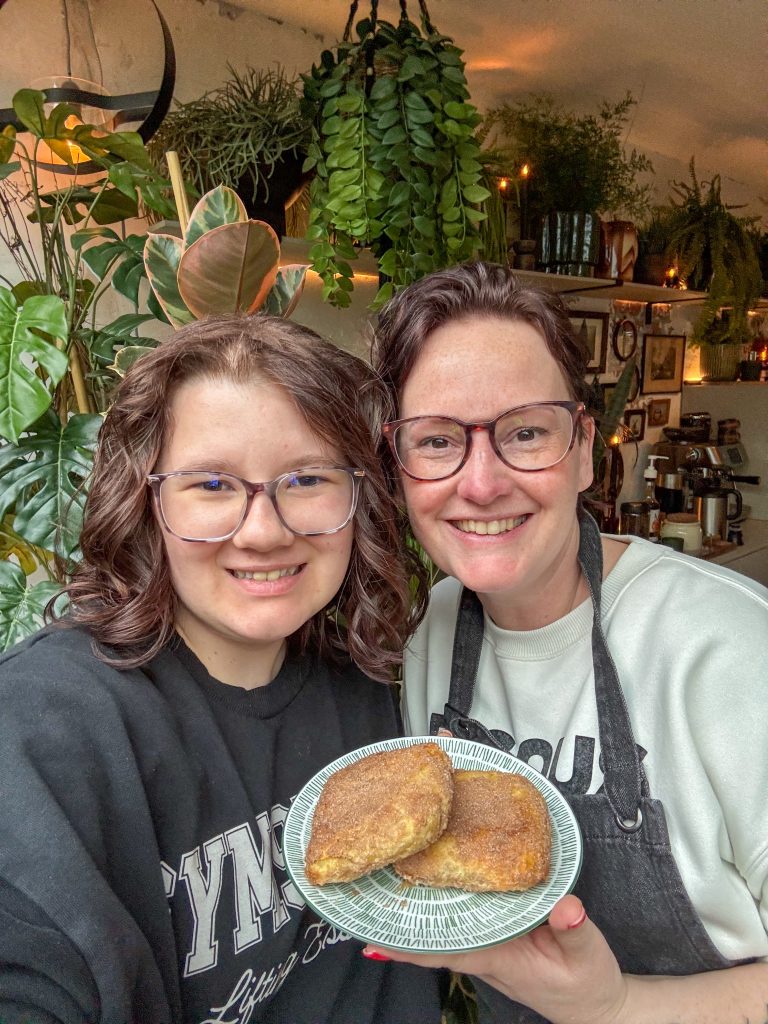 Beaudine en Marie Louise houden zelfgemaakte appel beignets vast